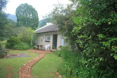 a house with a brick path leading to a yard at Sabie Star in Sabie