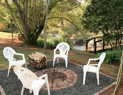 a group of white chairs sitting around a fire pit at Sabie Star in Sabie