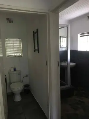 a bathroom with a toilet and a sink at Sabie Star in Sabie