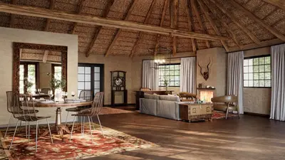 a living room with a couch and a table and chairs at Geiger's Camp in Timbavati Game Reserve by NEWMARK in Timbavati Game Reserve