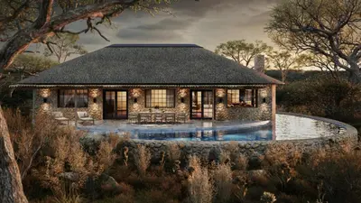 a house with a pool in front of it at Geiger's Camp in Timbavati Game Reserve by NEWMARK in Timbavati Game Reserve