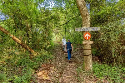 two people walking on a trail in the woods at AfriCamps at Mackers in Hazyview
