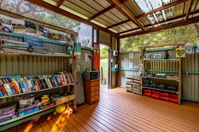a book store with books on shelves in a building at AfriCamps at Mackers in Hazyview