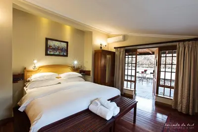 a bedroom with a large bed with towels on it at Kleinkaap Boutique Hotel in Centurion