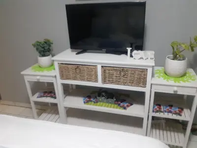 a white cabinet with a television on top of it at Ubuntu Guesthouse in Pretoria