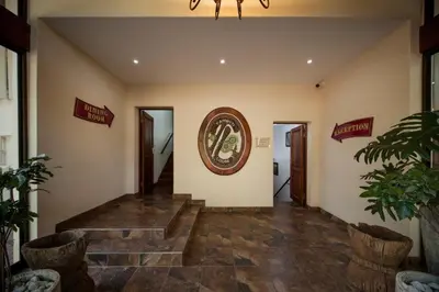 a lobby with a staircase and a picture on the wall at Tamboti Lodge Guest House in Tzaneen