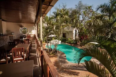 a resort with a swimming pool and a restaurant at Tamboti Lodge Guest House in Tzaneen