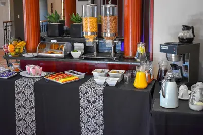 a buffet table with food and drinks on it at Waterfalls Boutique Hotel in Pretoria