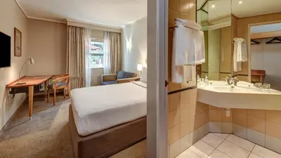 a hotel room with a bed and a bathroom at StayEasy Pretoria in Pretoria