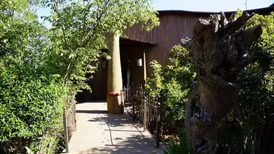 a building with a fence in front of it at Leopards Rock Bush Boutique in Bela-Bela