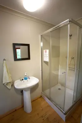 a bathroom with a sink and a shower at Zongororo Mountain Lodge in Waterval-Onder