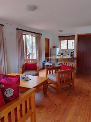 a living room with a table and chairs at Zongororo Mountain Lodge in Waterval-Onder
