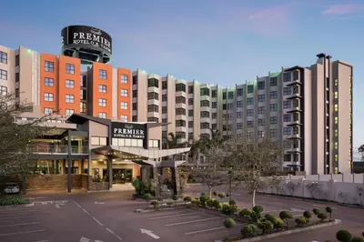 a large building with a parking lot in front of it at Premier Hotel O.R. Tambo in Kempton Park