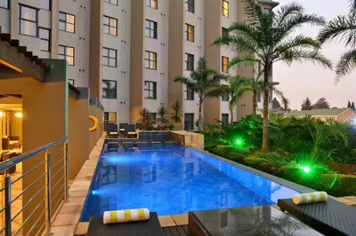 a swimming pool in front of a hotel at Premier Hotel O.R. Tambo in Kempton Park