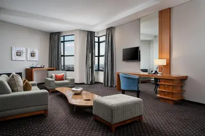 a living room with a couch and a table at Premier Hotel O.R. Tambo in Kempton Park