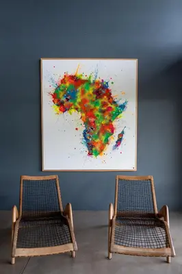 two chairs in a room with a painting on the wall at Tamboti River Lodge in Hectorspruit