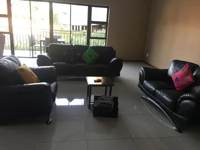 a living room with two couches and a table at Vahlavi Lodge in Giyani