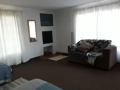 a living room with a couch and a window at Dullstroom on the Dam in Dullstroom