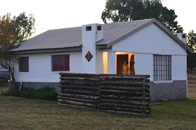 a couple standing in the doorway of a house at Dullstroom on the Dam in Dullstroom