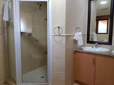 a bathroom with a shower and a sink at Kruger Park Lodge ITR01 3 Bedroom in Hazyview