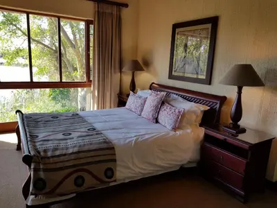 a bedroom with a bed with pillows and a window at Kruger Park Lodge ITR01 3 Bedroom in Hazyview