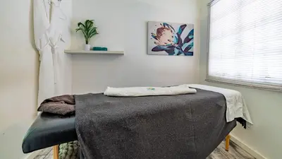 a room with a table with a blanket on it at Hotel Numbi & Garden Suites in Hazyview