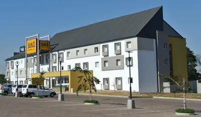 a large white building with a black roof at SUN1 WITBANK in Witbank