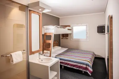 a small room with a bunk bed and a sink at SUN1 WITBANK in Witbank