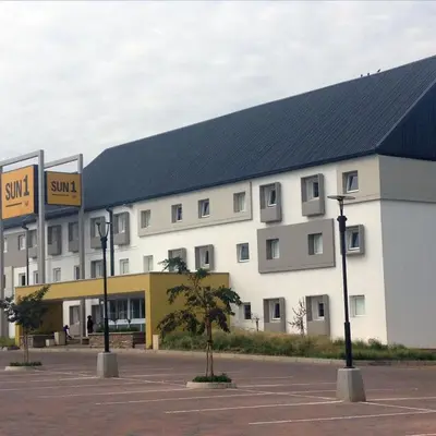 a large white building with a black roof at SUN1 WITBANK in Witbank