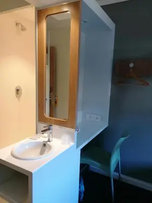 a bathroom with a sink and a mirror at SUN1 WITBANK in Witbank