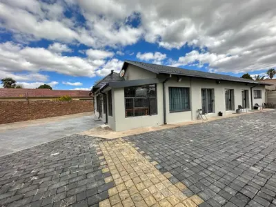a building with a brick driveway in front of it at Favour Guest house in Polokwane