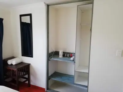a bathroom with a mirror and a closet at Home @ Harry's in Pretoria