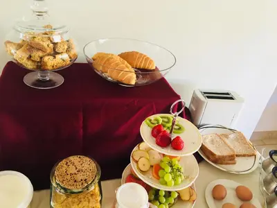 a table topped with plates of food and bread at At The Rocks Country Estate in Avondzon