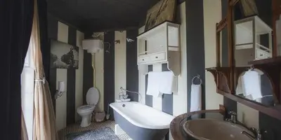 a bathroom with a tub and a toilet and a sink at Schoon Huis Manor in Kempton Park