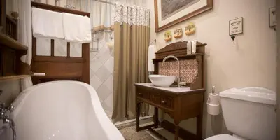 a bathroom with a tub and a sink and a toilet at Schoon Huis Manor in Kempton Park