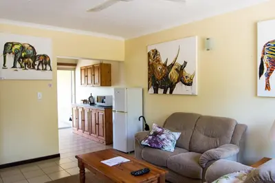 a living room with a couch and a table at Cuckoo Ridge Country Retreat in Hazyview