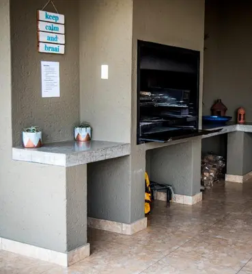 a counter in a fast food restaurant with two plants at Crocodile Bend in Mpakeni