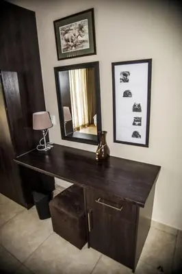 a desk with a mirror and a lamp in a room at Crocodile Bend in Mpakeni