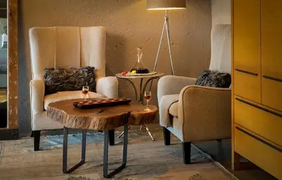 a living room with two chairs and a coffee table at Pondoro Game Lodge in Balule Game Reserve