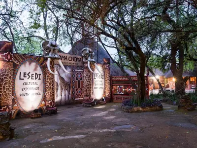 a building with signs on the side of it at aha Lesedi African Lodge & Cultural Village in Pelindaba