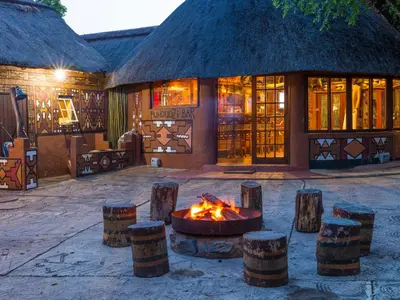 a fire pit in front of a building at aha Lesedi African Lodge & Cultural Village in Pelindaba