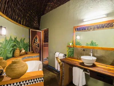 a bathroom with a sink and a mirror at aha Lesedi African Lodge & Cultural Village in Pelindaba