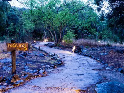 a sign that reads novy on a dirt road at aha Lesedi African Lodge & Cultural Village in Pelindaba