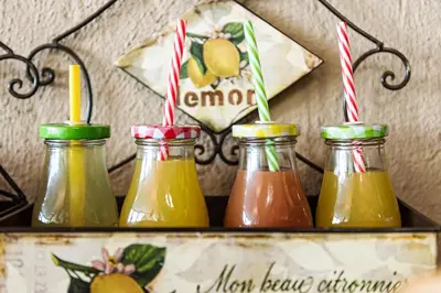 a shelf with four jars of different colored drinks at Glenda's Guest Suites in Midrand