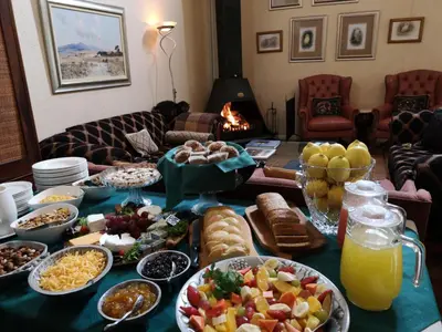 a table topped with lots of different types of food at Stonecutters Lodge in Dullstroom