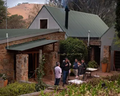 a group of people standing outside of a house at Stonecutters Lodge in Dullstroom
