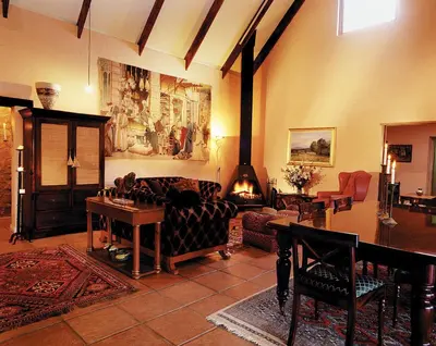 a living room with a couch and a table at Stonecutters Lodge in Dullstroom