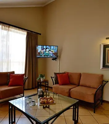 a living room with a couch and a glass table at Monateng Safari Lodge in Wallmannstal