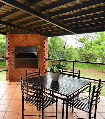 a black table and chairs on a patio at Monateng Safari Lodge in Wallmannstal