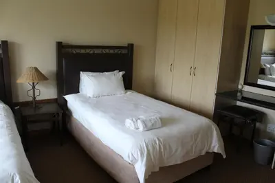 a hotel room with a bed with two towels on it at Monateng Safari Lodge in Wallmannstal